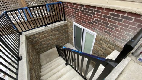 Close up image of a stair in black color and a supporter