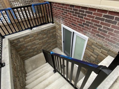 Close up image of a stair in black color and a supporter